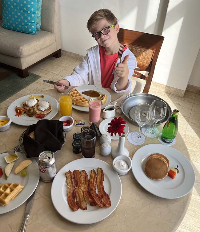 Kid enjoying room service in his room at the Grand Fiesta Americana Coral Beach, Cancun Mexico